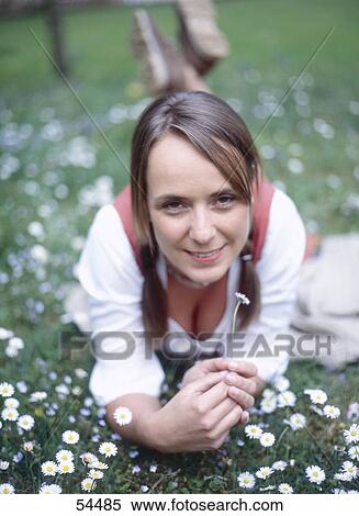 Smiling woman lying on meadow, elevated view View Large Photo Image Stock Photography - Smiling woman lying on meadow, elevated view . Fotosearch