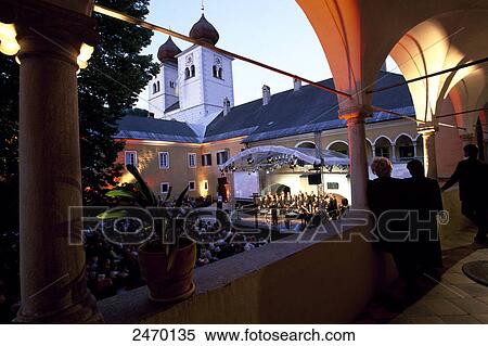 Stock Photography - Spectators witnessing performance in courtyard of church . Fotosearch