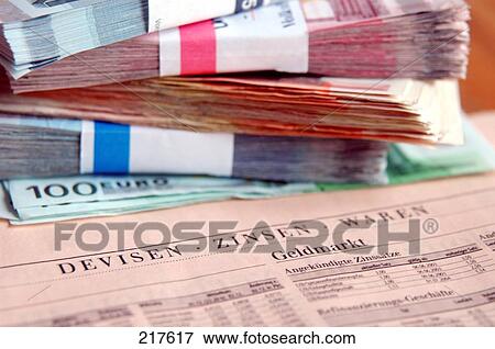 Stock Photo - Stack of European Union Euro notes on newspaper . Fotosearch