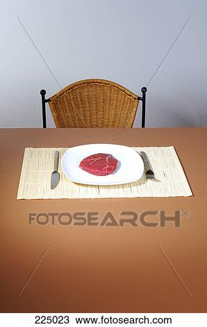 steak on a plate on a table View Large Photo Image Stock Image - steak on a plate on a table . Fotosearch