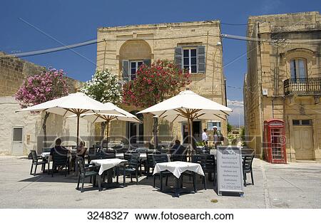 Stock Photo - Street cafe and cathedral, San Lawrenz, Gozo, Malta . Fotosearch