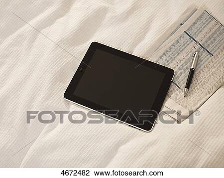 Stock Image - Tablet PC and newspaper . Fotosearch
