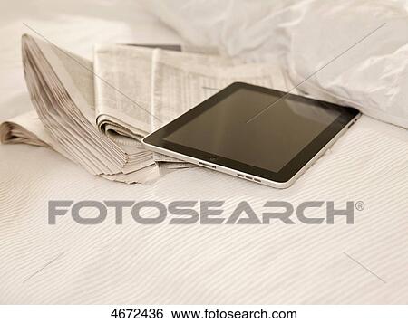 Stock Photograph - Tablet PC and newspaper . Fotosearch