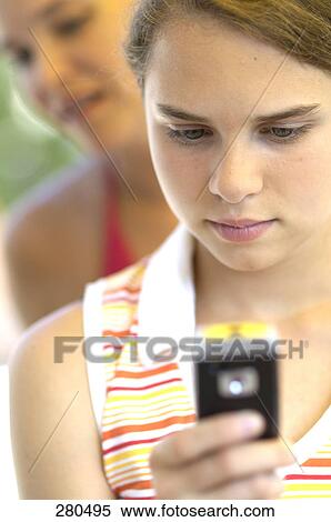 Stock Photography - Teenage girl using mobile phone . Fotosearch