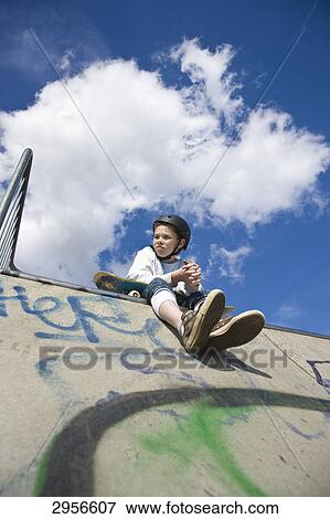 Stock Photo - teenage skateboarder, view from below . Fotosearch
