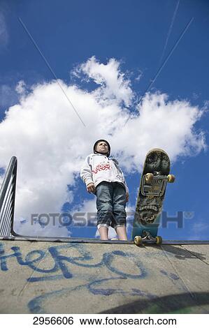 Stock Photograph - teenage skateboarder, view from below . Fotosearch