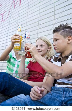 Three children toasting with alcohol, low angle view View Large Photo Image Stock Image - Three children toasting with alcohol, low angle view . Fotosearch