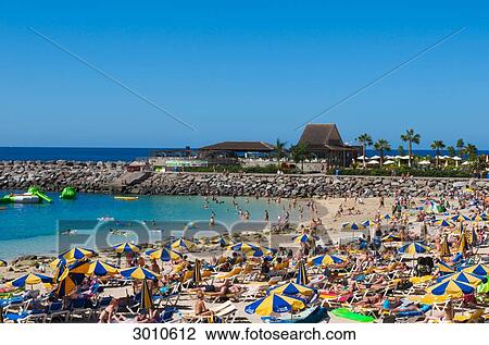 Stock Image - Tourists at Playa de Amadores, Puerto Rico, Grand Canary, Canary . Fotosearch