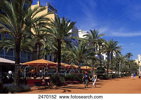 Tourists holding hands and walking near sidewalk cafe View Large Photo Image Stock Image - Tourists holding hands and walking near sidewalk cafe . Fotosearch