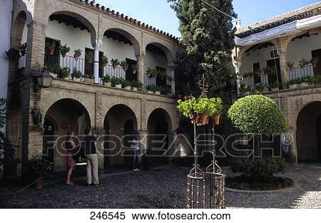 Stock Photography - Tourists in courtyard of house, Cordoba, Andalusia, Spain . Fotosearch
