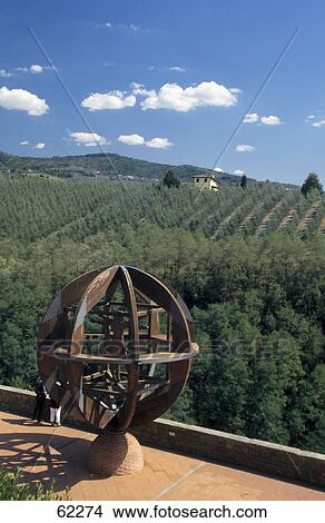 Tourists near a globe sculpture overlooking olive trees, Vinci, Tuscany, Italy View Large Photo Image Picture - Tourists near a globe sculpture overlooking olive trees, Vinci, Tuscany, Italy . Fotosearch