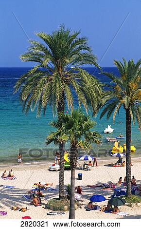 Stock Image - Tourists on beach, Platja d'en Bossa, Ibiza, Balearic Islands, Spain . Fotosearch
