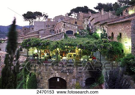 Stock Image - Tourists sitting at sidewalk cafe, Spain . Fotosearch