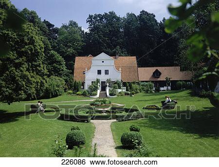 Stock Photograph - Tourists sitting in formal garden, Barkenhoff, Worpswede, Germany . Fotosearch