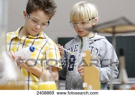 Stock Photo - Two boys doing science experiments . Fotosearch