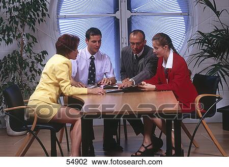 Stock Image - Two businessmen and businesswomen discussing in meeting . Fotosearch