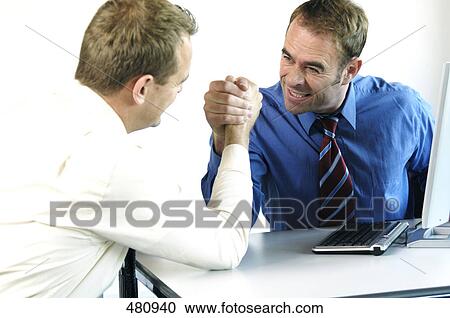 Two businessmen arm wrestling in office View Large Photo Image Stock Image - Two businessmen arm wrestling in office . Fotosearch