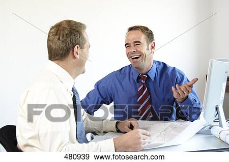 Two businessmen smiling in office View Large Photo Image Stock Photo - Two businessmen smiling in office . Fotosearch