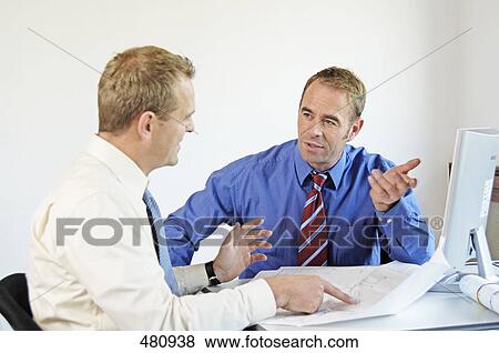 Two businessmen talking to each other View Large Photo Image Stock Photo - Two businessmen talking to each other . Fotosearch