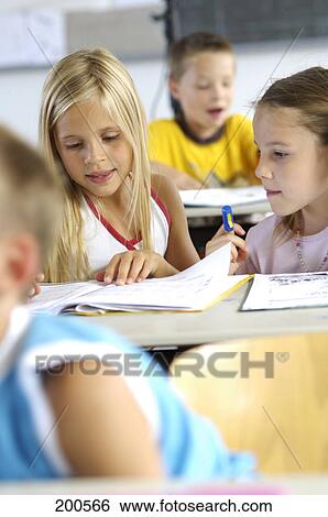 Two girls studying in a classroom View Large Photo Image Stock Photograph - Two girls studying in a classroom . Fotosearch