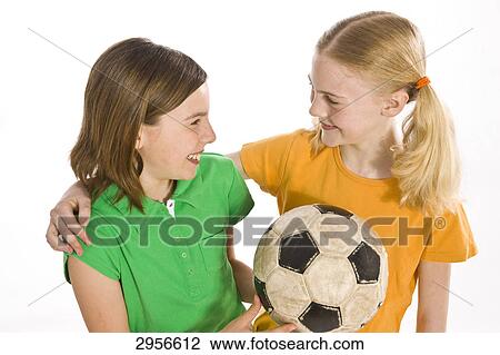 Stock Image - two girls with a football . Fotosearch