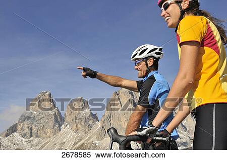 Two mountain bikers smiling together, Italy View Large Photo Image Stock Photography - Two mountain bikers smiling together, Italy . Fotosearch