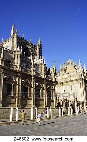 Two people walking in front of cathedral, Santa Maria Cathedral, Seville, Andalusia, Spain View Large Photo Image Stock Image - Two people walking in front of cathedral, Santa Maria Cathedral, Seville, Andalusia, Spain . Fotosearch