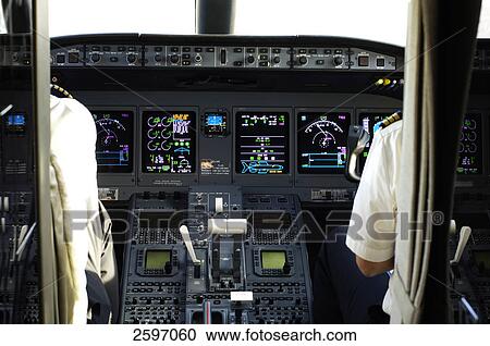 Stock Image - Two pilots in cockpit of airplane . Fotosearch