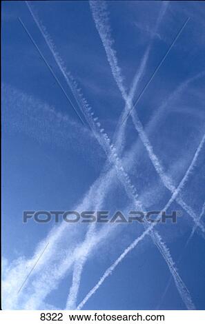 Vapor trails against blue sky View Large Photo Image Stock Image - Vapor trails against blue sky . Fotosearch