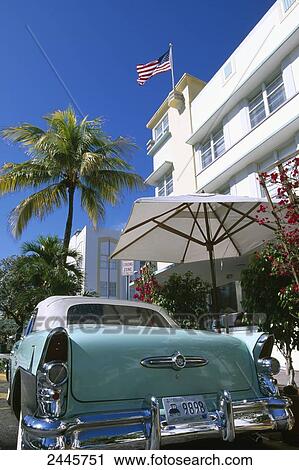 Stock Image - Vintage car parked in front of building . Fotosearch
