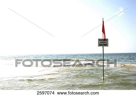 Picture - Warning sign in shallow water on beach . Fotosearch