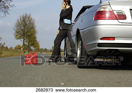 Woman having car breakdown, low angle view View Large Photo Image Stock Image - Woman having car breakdown, low angle view . Fotosearch