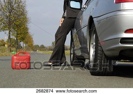 Picture - Woman having car breakdown, lower section . Fotosearch