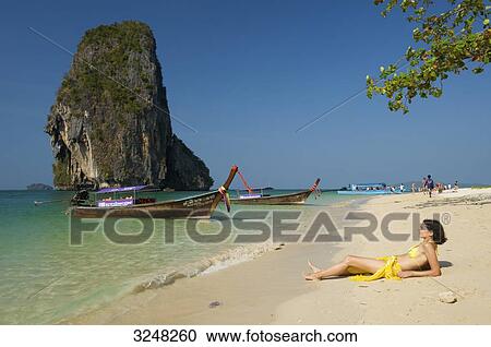 Woman lying at Laem Phra Nang Beach, Krabi, Thailand View Large Photo Image Stock Image - Woman lying at Laem Phra Nang Beach, Krabi, Thailand . Fotosearch