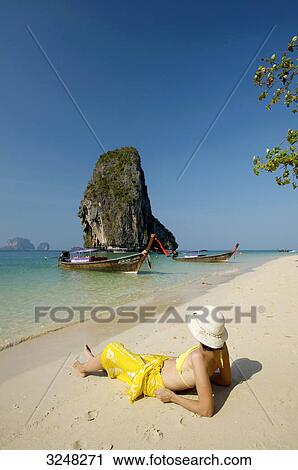 Woman lying at Laem Phra Nang Beach, Krabi, Thailand View Large Photo Image Stock Image - Woman lying at Laem Phra Nang Beach, Krabi, Thailand . Fotosearch