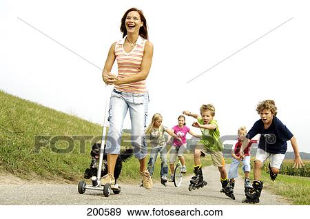 Woman playing with children on road View Large Photo Image Stock Photo - Woman playing with children on road . Fotosearch