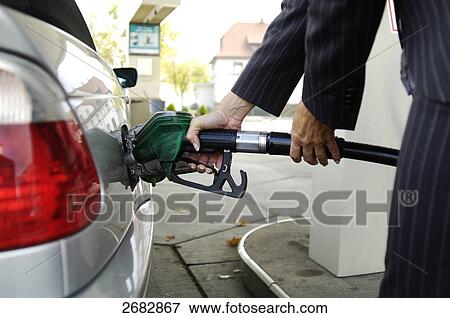 Woman refueling car at gas station View Large Photo Image Stock Photo - Woman refueling car at gas station . Fotosearch