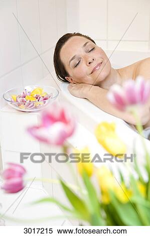 Woman relaxing in a bath tub View Large Photo Image Stock Photography - Woman relaxing in a bath tub . Fotosearch