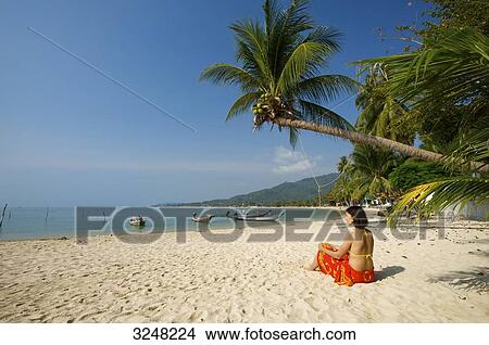 Woman sitting at Lamai Beach, Ko Samui, Thailand View Large Photo Image Picture - Woman sitting at Lamai Beach, Ko Samui, Thailand . Fotosearch