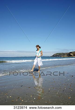 Woman walking down the beach View Large Photo Image Picture - Woman walking down the beach . Fotosearch