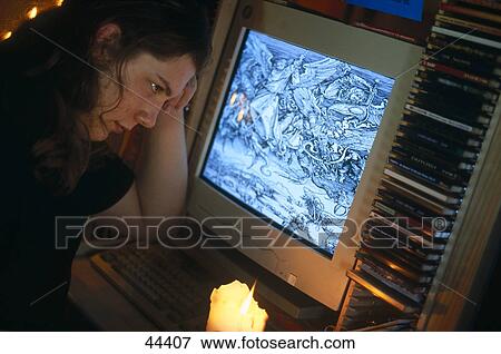 Young man looking at computer View Large Photo Image Stock Photo - Young man looking at computer . Fotosearch