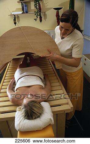 Stock Photograph - Young woman lying on massage table . Fotosearch