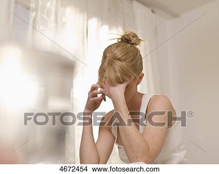Picture - Young woman phoning in bed . Fotosearch