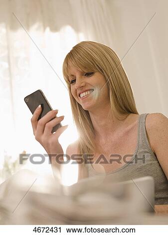 Young woman phoning in bed View Large Photo Image Stock Image - Young woman phoning in bed . Fotosearch