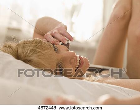 Young woman phoning in bed View Large Photo Image Stock Photo - Young woman phoning in bed . Fotosearch
