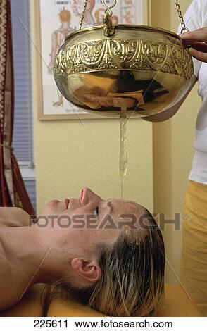 Young woman receiving shirodhara therapy View Large Photo Image Stock Image - Young woman receiving shirodhara therapy . Fotosearch