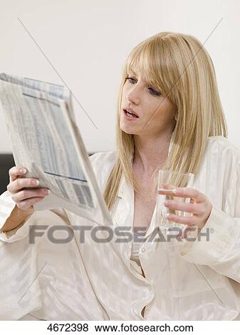 Young woman sitting in bed View Large Photo Image Stock Photo - Young woman sitting in bed . Fotosearch