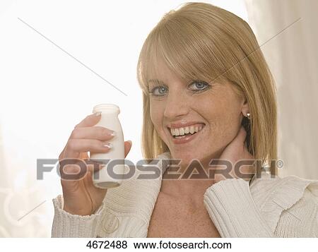 Young woman smiling at camera View Large Photo Image Stock Photo - Young woman smiling at camera . Fotosearch