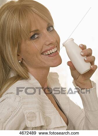 Stock Photo - Young woman smiling at camera . Fotosearch