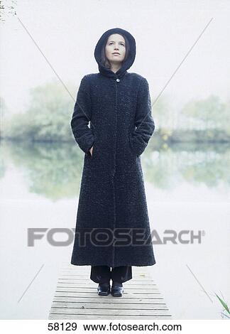 Young woman standing on pier View Large Photo Image Stock Photo - Young woman standing on pier . Fotosearch